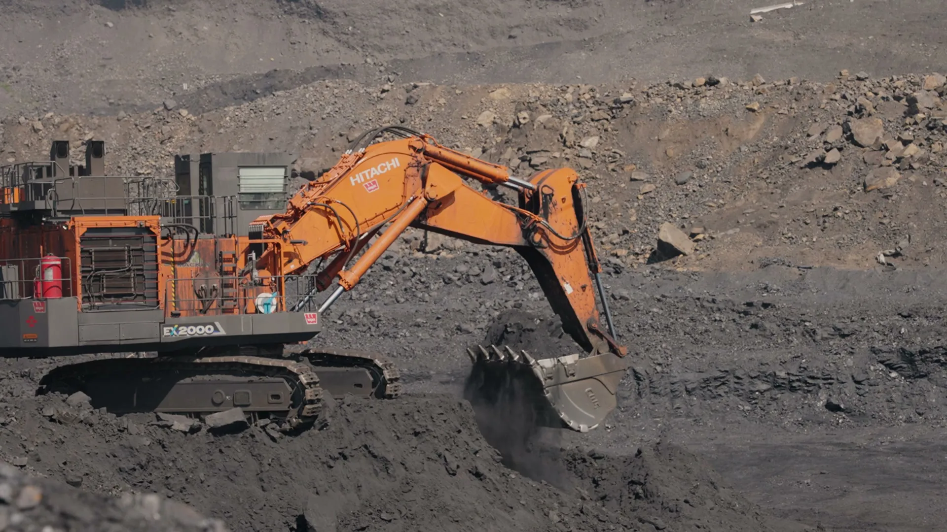 Hitachi EX2000 excavator digging on an active mine bench