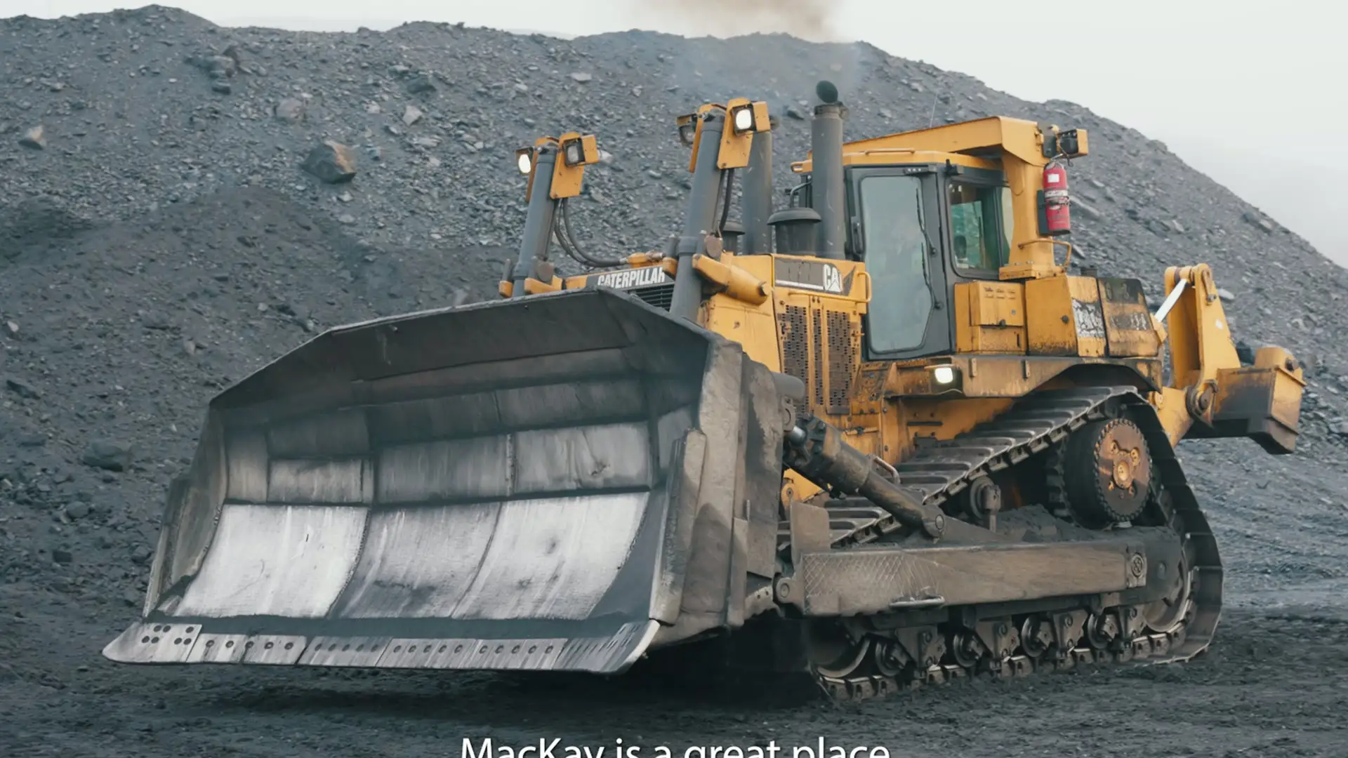 Mackay dozer working a misty mine bench